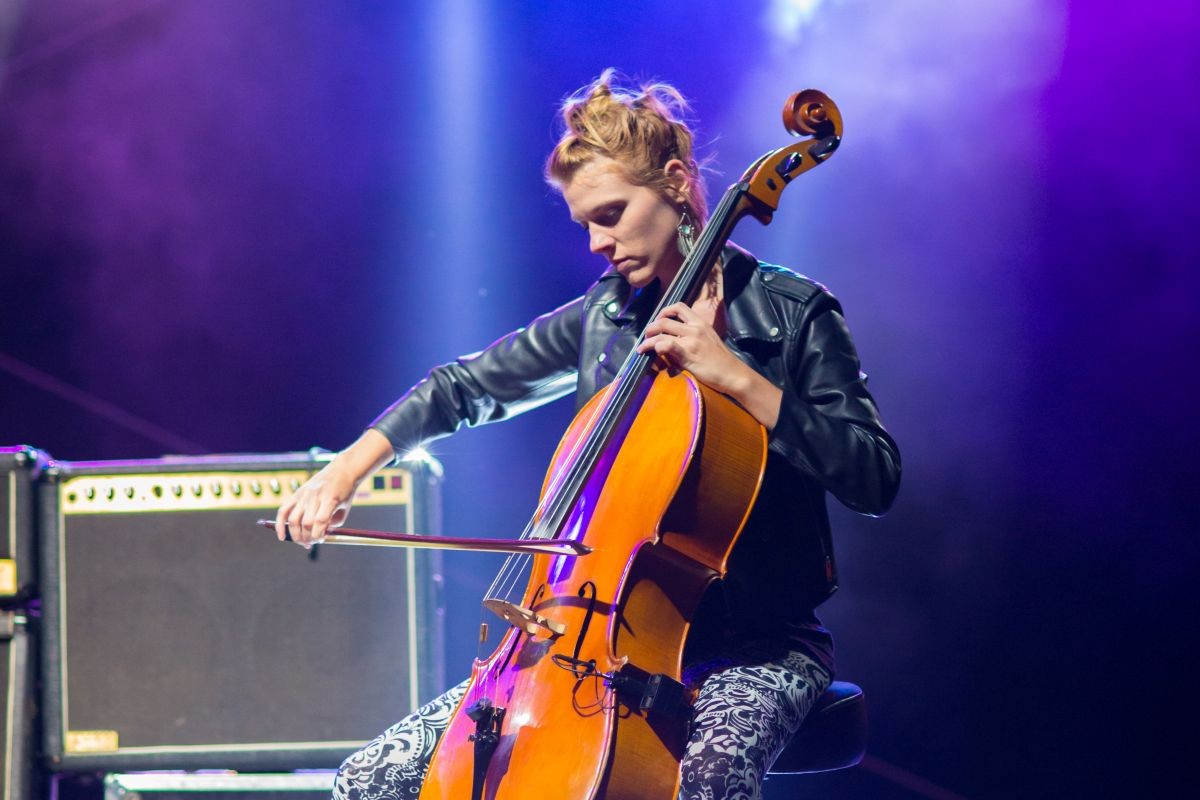 Female performing while playing the Cello